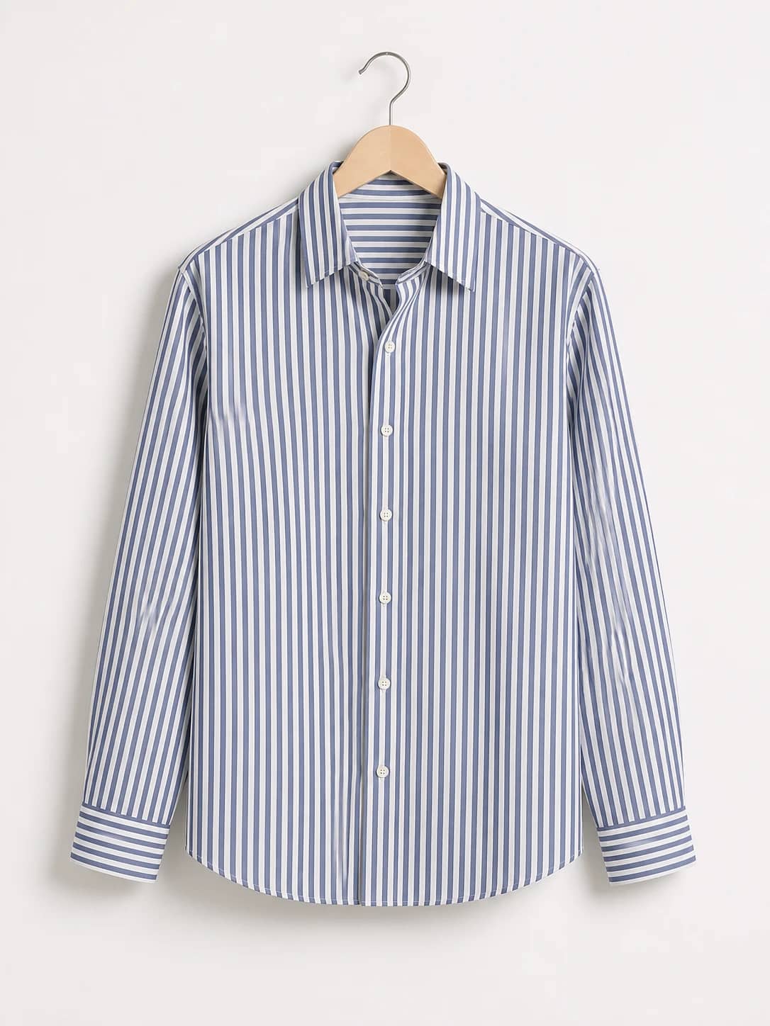 Blue and ivory striped button-up shirt photographed on a wooden hanger