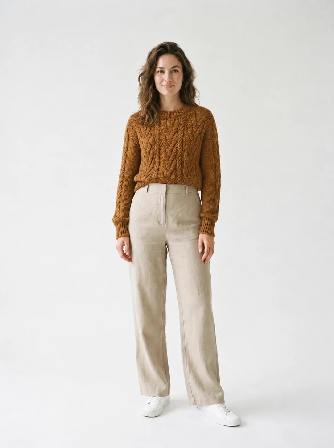On-model image of Model 1 wearing the caramel cable-knit sweater