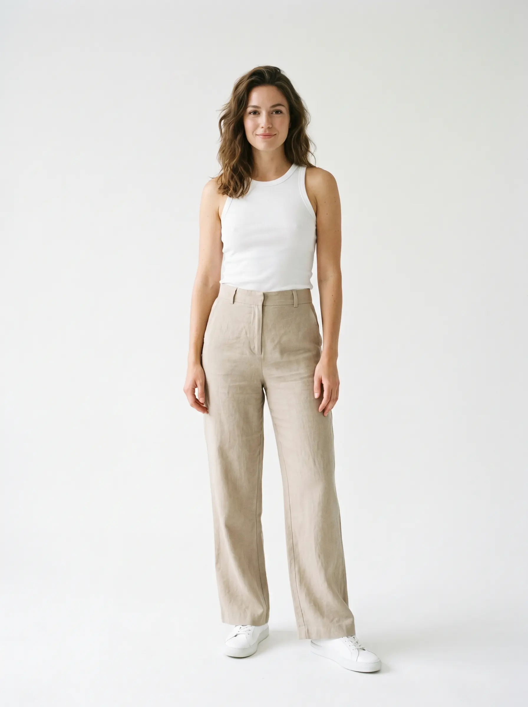 Preset fashion model: woman in a plain white tank top and beige trousers on a neutral studio background