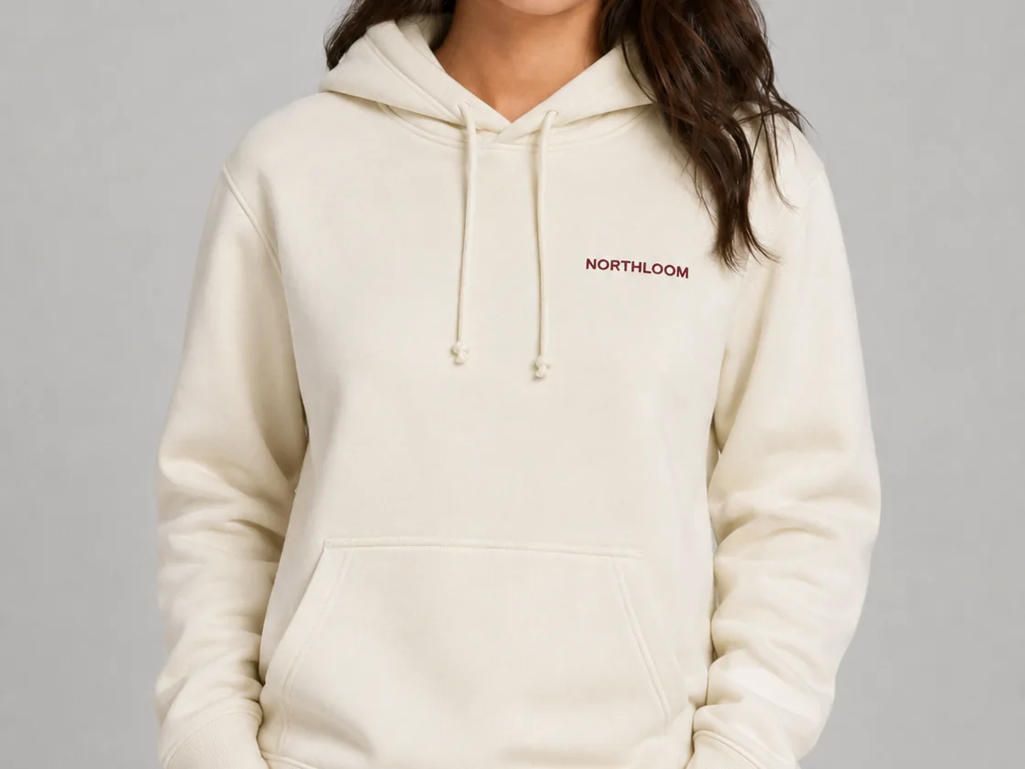 Unedited AI try-on output: cream hoodie with the chest logo still sharp and readable